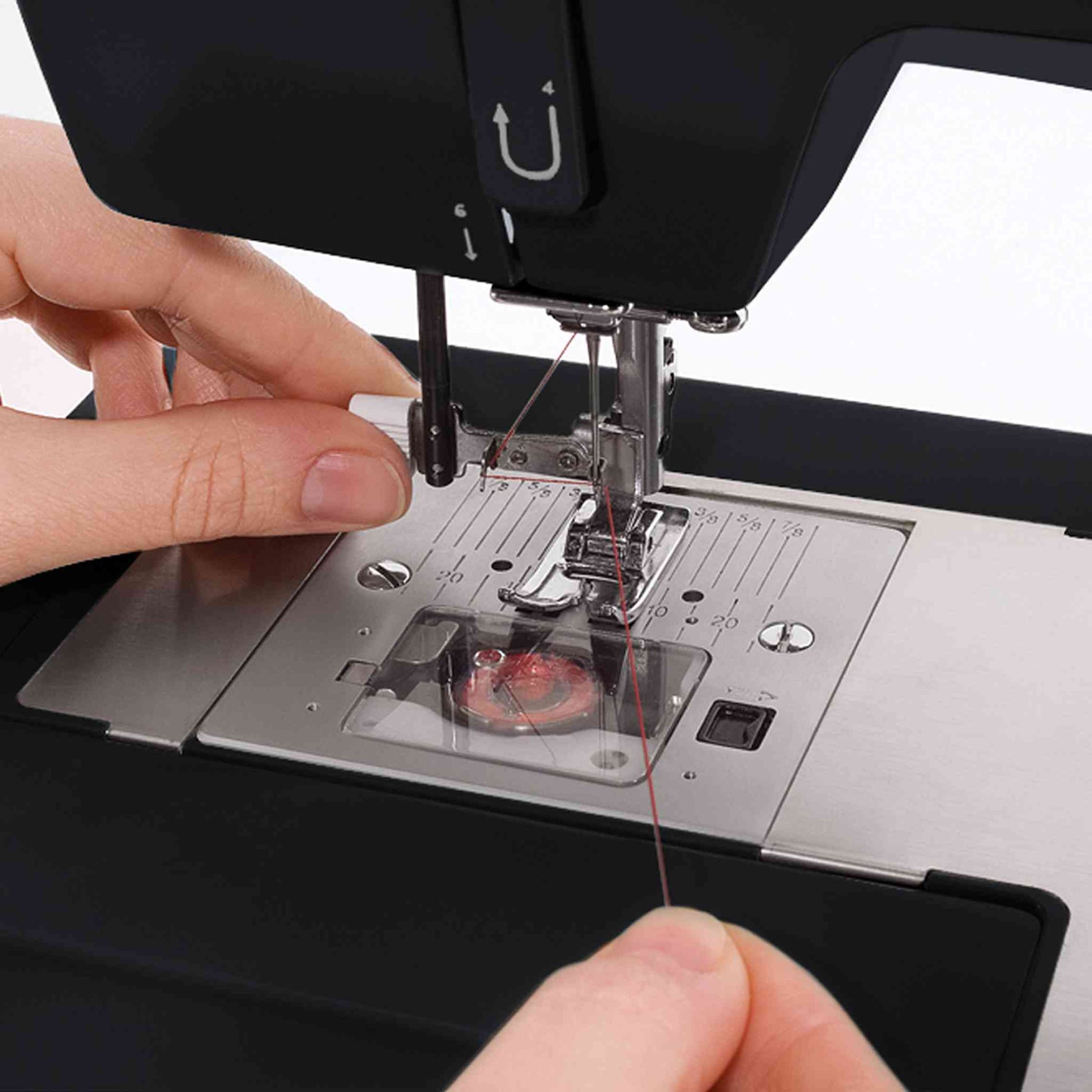 Singer 4432 sewing machine showing black needle threader