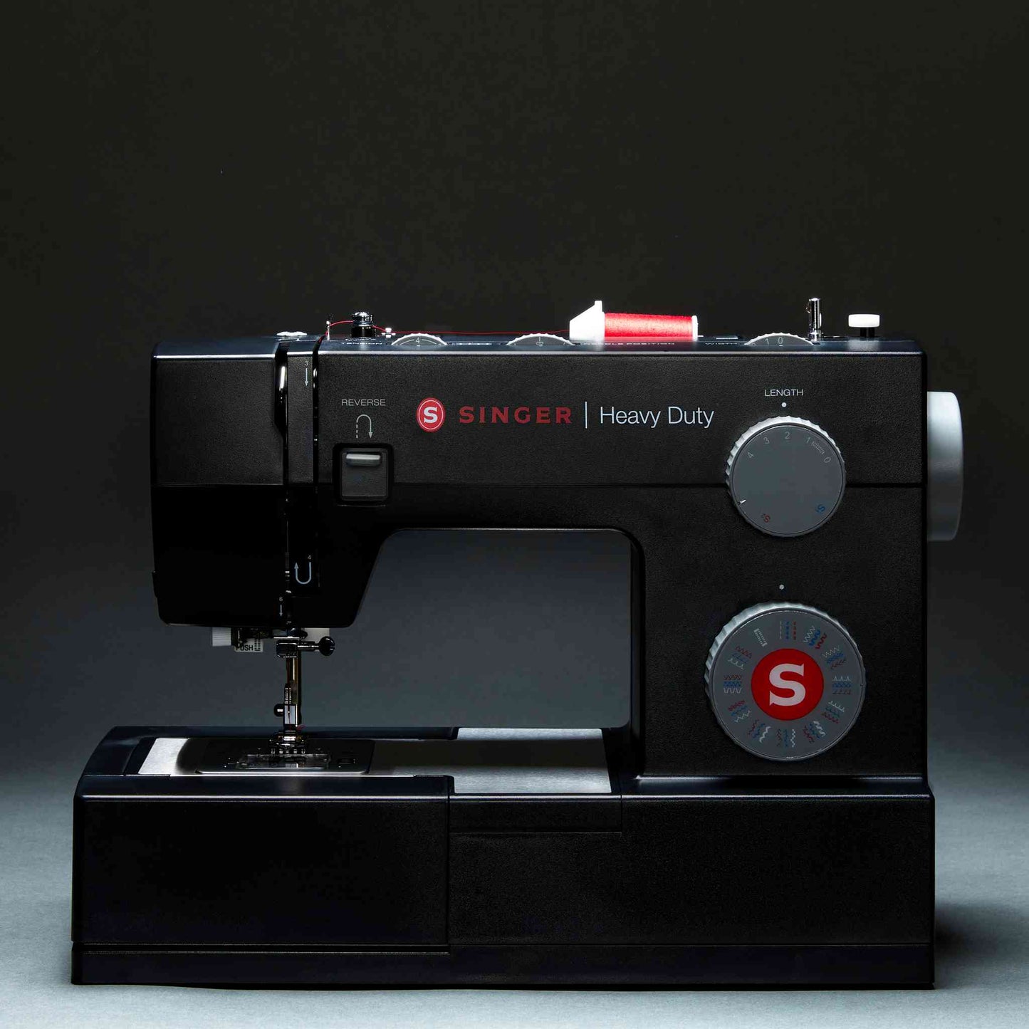 Singer 4432 sewing machine in black shown with dark background and front display
