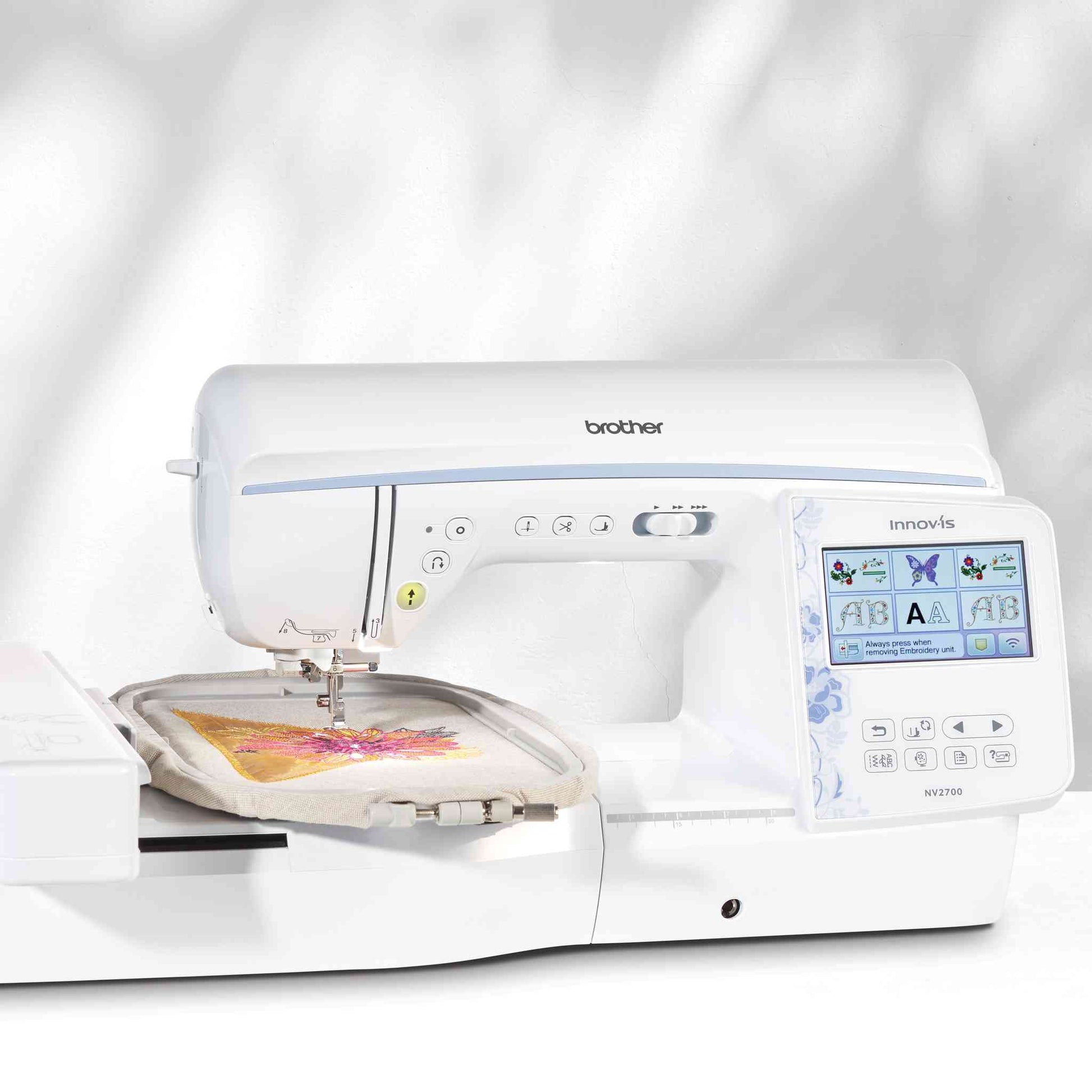brother nv2700 sewing and embroidery machine with embroidery unit stitching out a thread design