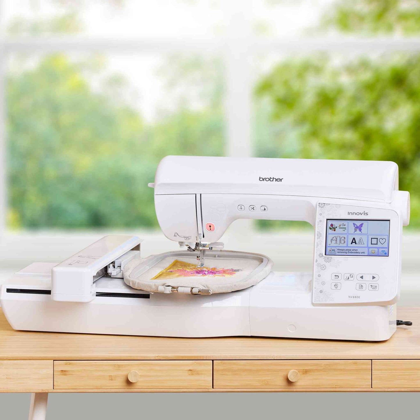 brother nv880e sewing and embroidery machine on a sunny studio desk