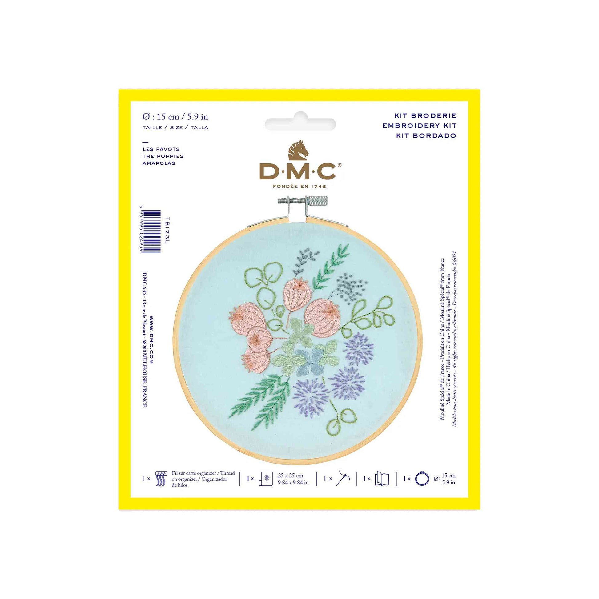 DMC Poppies Embroidery Kit on a white background. The kit comes with light blue fabric, a wooden embroidery hoop and features embroideries of various flowers and leaves including poppies