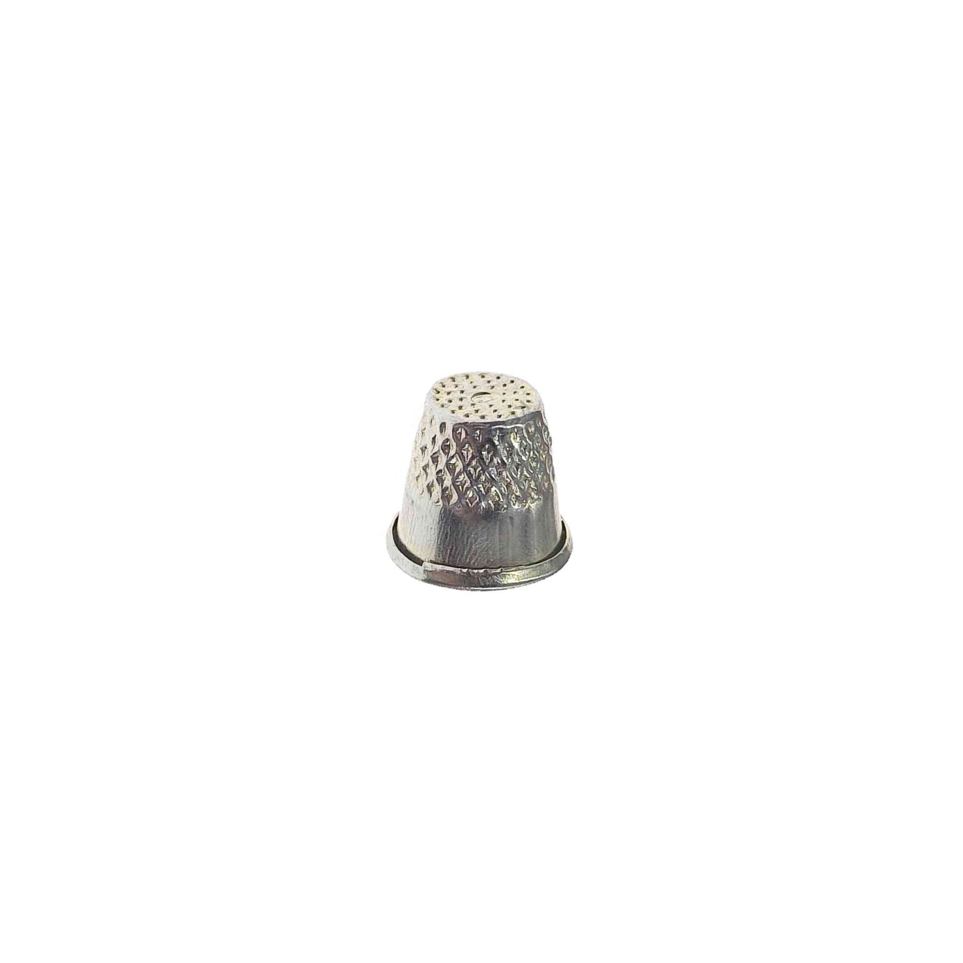 Metal alloy cap sewing thimble on white background