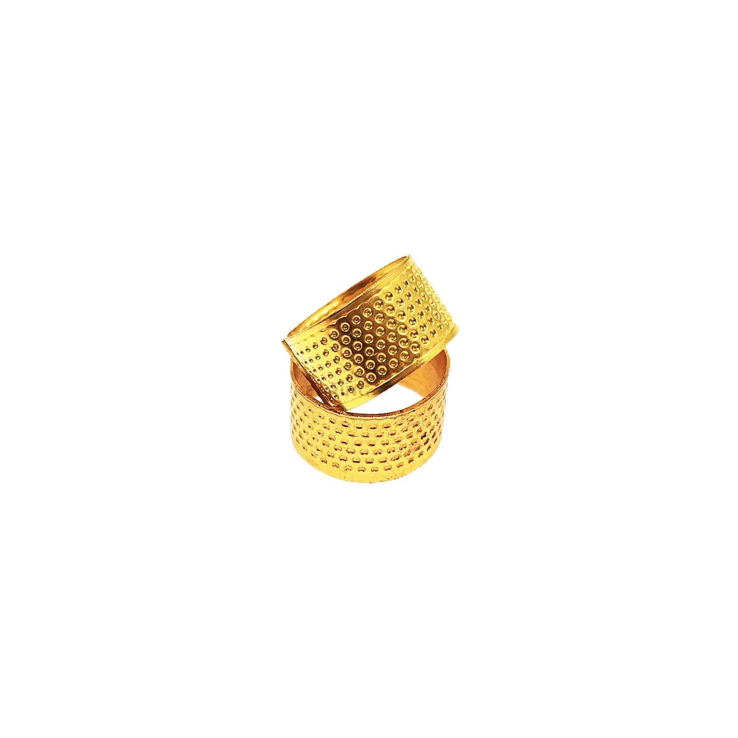 Yellow metal thimble rings stacked on white background