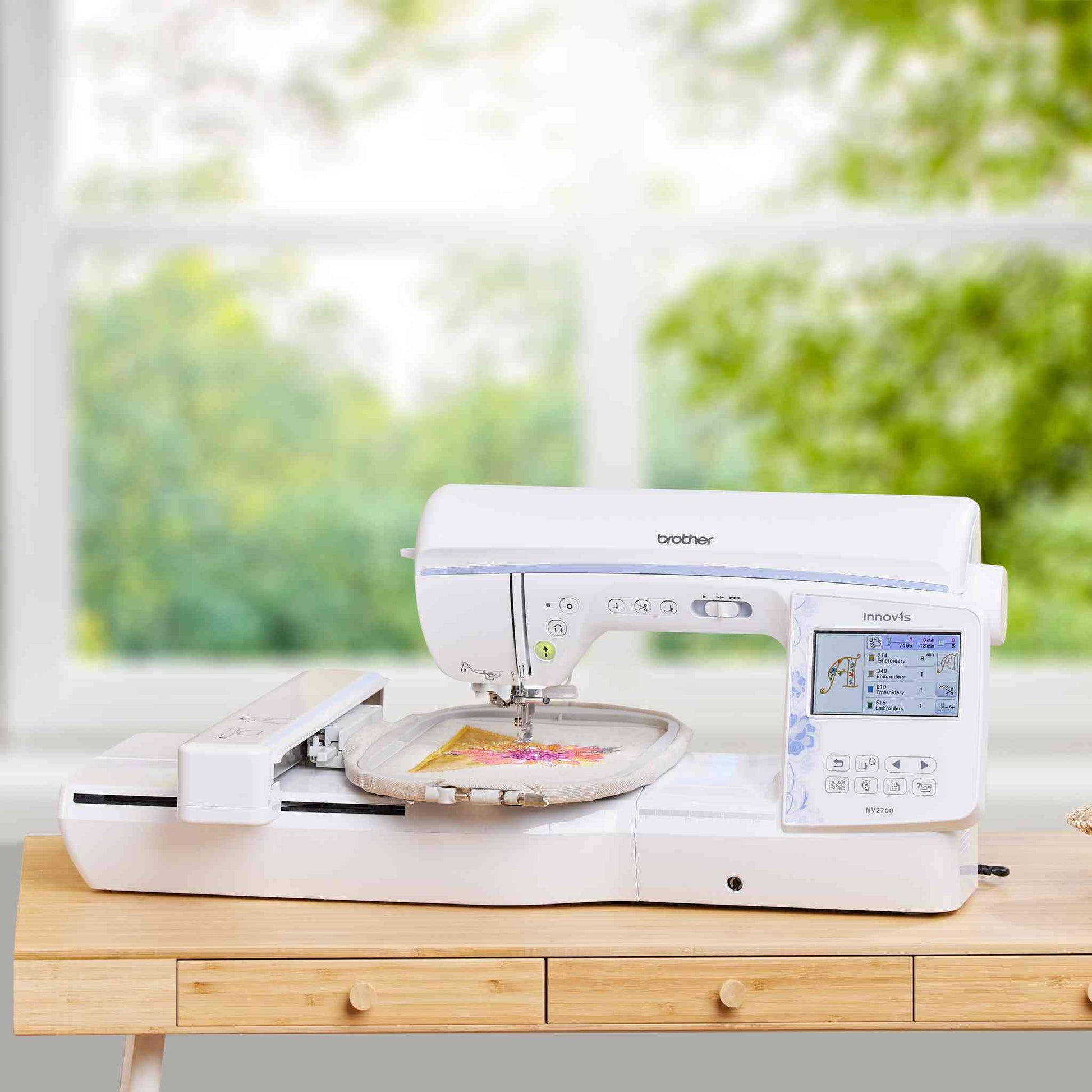 brother nv2700 sewing and embroidery machine with embroidery unit on a studio table